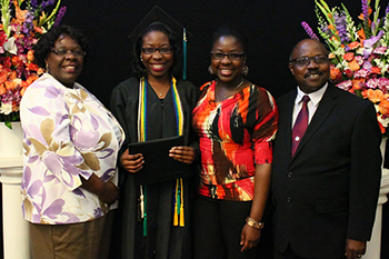 Heald College graduate with family at reception hosted by Warner Pacific at Mt. Scott Church of God May 2015