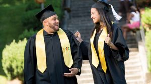 Two graduates walking outside