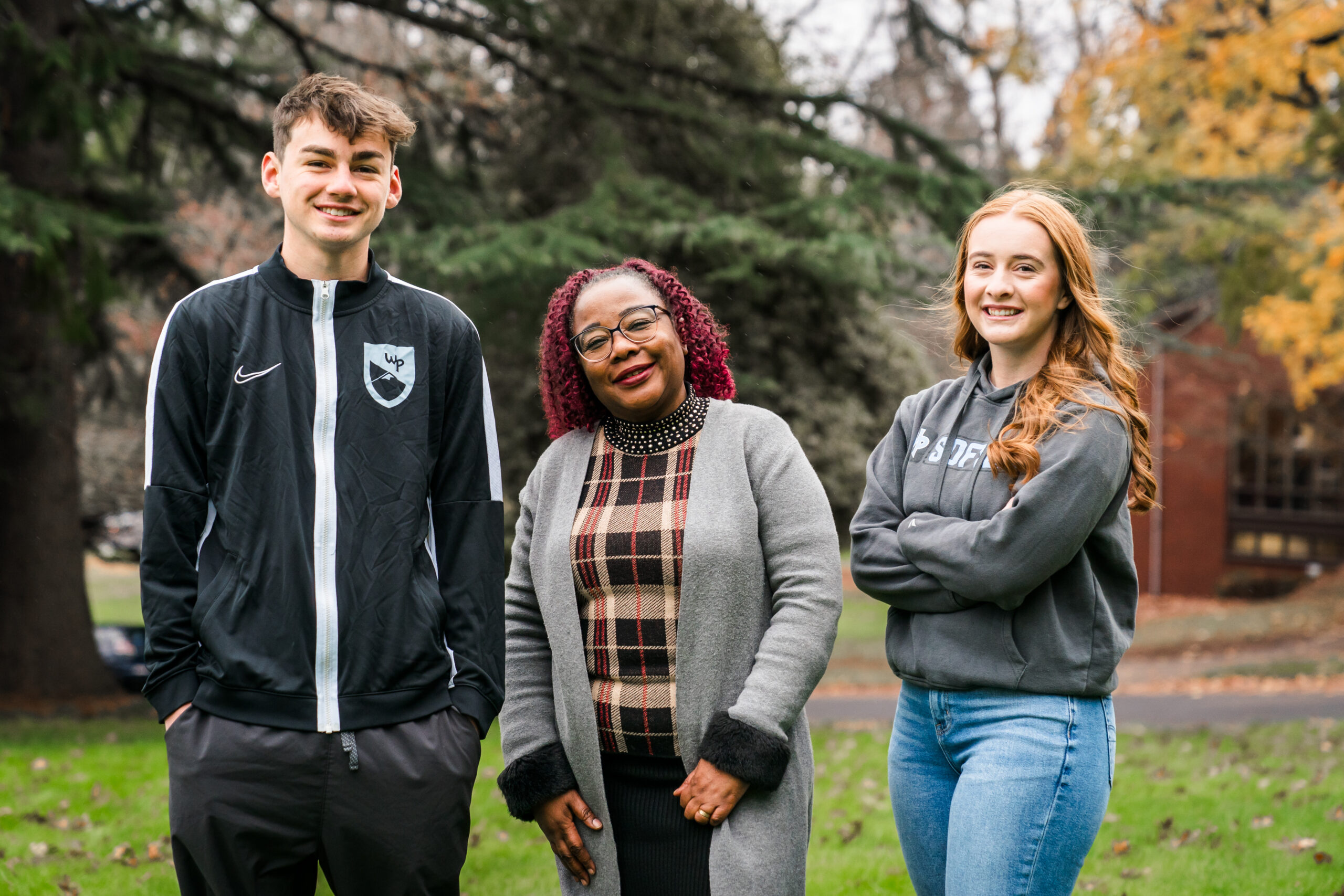 Two students and a professor outdoors on the WPU campus.