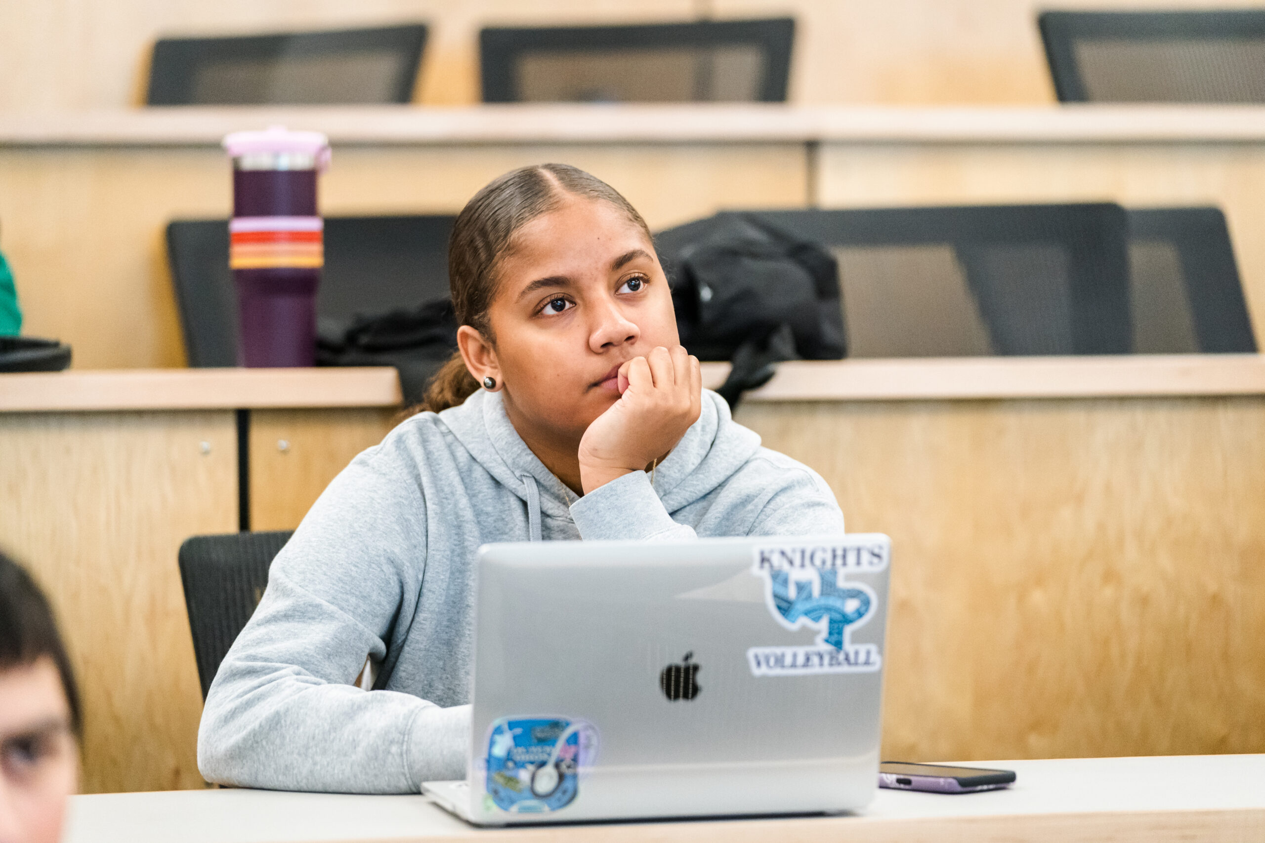 A student sitting in a teaching auditorium at Warner Pacific University.