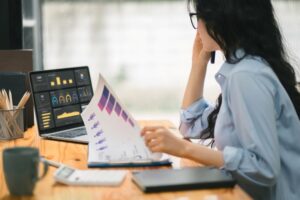 A budget analyst reviewing financial documents in an office.
