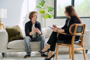 A behavioral health specialist talks with a client in an office.