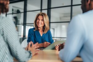 A financial advisor meets with clients in her office.